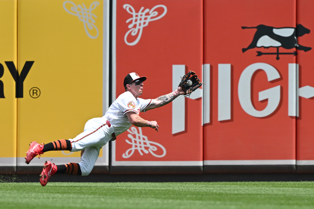 Baltimore Orioles right fielder Tyler O'Neill (9) makes a diving catch against the Chicago White Sox in the fourth inning of a MLB baseball game on Wednesday, July 1, 2026 in Baltimore, Md. (AP Photo/Gail Burton)