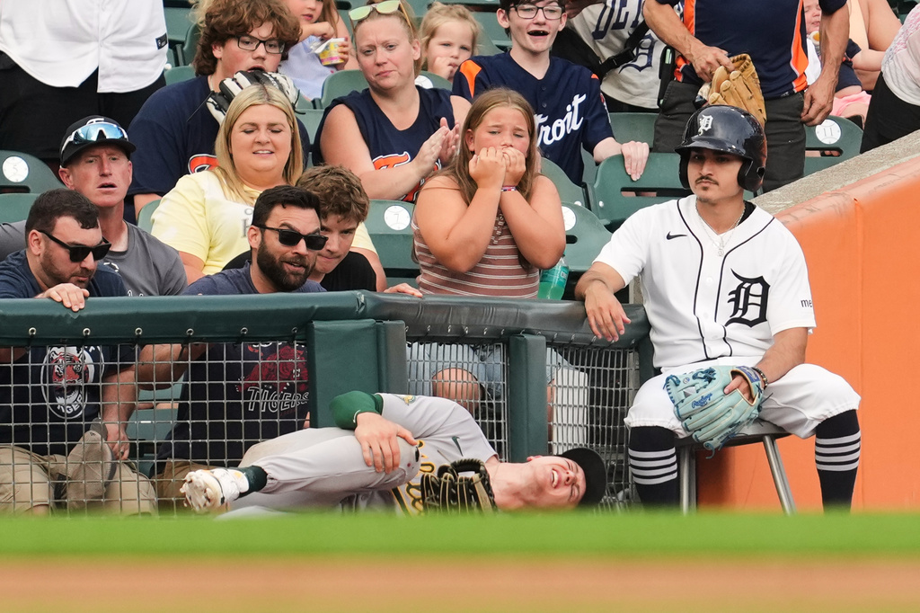 FILE - Athletics left fielder Zack Gelof grabs his leg after contacting the fence while catching a Detroit Tigers' Zach McKinstry fly ball in foul territory during the third inning of a baseball game Thursday, July 9, 2026, in Detroit. (AP Photo/Paul Sancya, File)