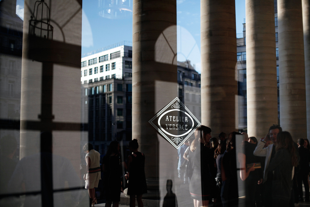 FILE - A window displays the Atelier Versace logo in Paris, France, Sunday, July 5, 2015. (AP Photo/Thibault Camus, File)
