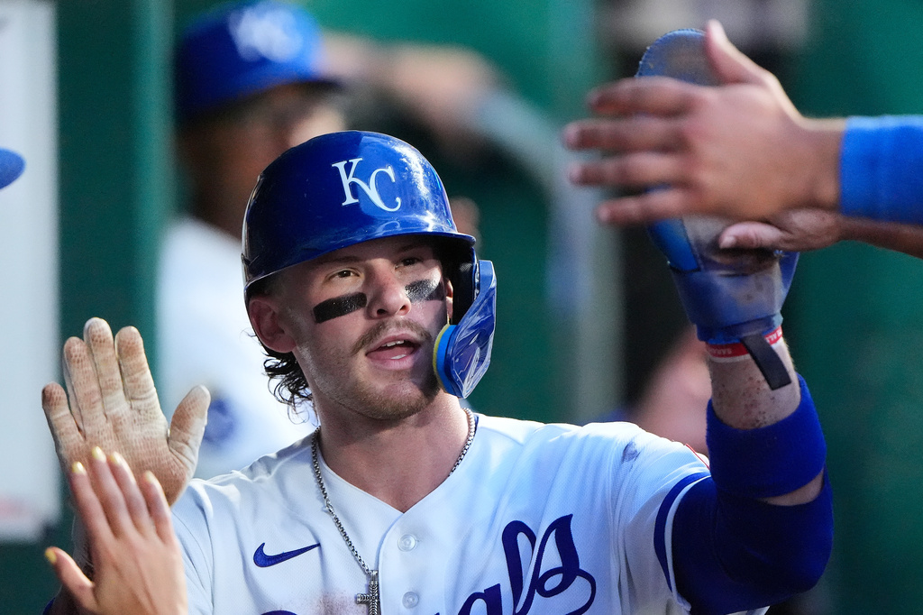 Kansas City Royals' Bobby Witt Jr. celebrates in the dugout after scoring on a fielder's choice hit into by Jac Caglianone during the fifth inning of a baseball game against the Minnesota Twins, Tuesday, Aug. 4, 2026, in Kansas City, Mo. (AP Photo/Charlie Riedel)