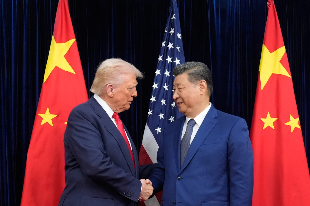 FILE - President Donald Trump, left, and Chinese President Xi Jinping, right, shake hands before their meeting at Gimhae International Airport in Busan, South Korea, Oct. 30, 2025. (AP Photo/Mark Schiefelbein, File)