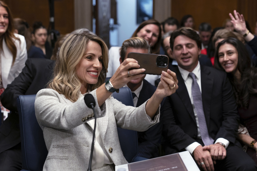 Dr. Nicole Saphier, surgeon general nominee, takes a selfie with family members before testifying at the Senate Committee on Health, Education, Labor and Pensions during her confirmation hearing on Capitol Hill Wednesday, Sept. 16, 2026, in Washington. (AP Photo/Jose Luis Magana)