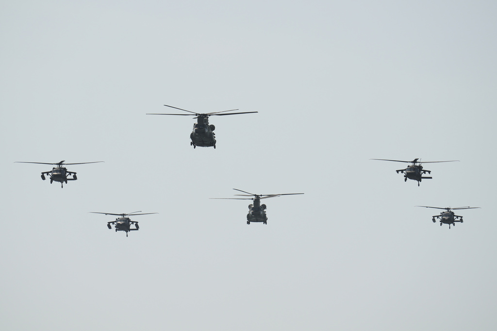 Helicopters fly during a U.S.-sponsored multinational military exercise in Panama City, Thursday, Aug. 13, 2026. (AP Photo/Matias Delacroix)