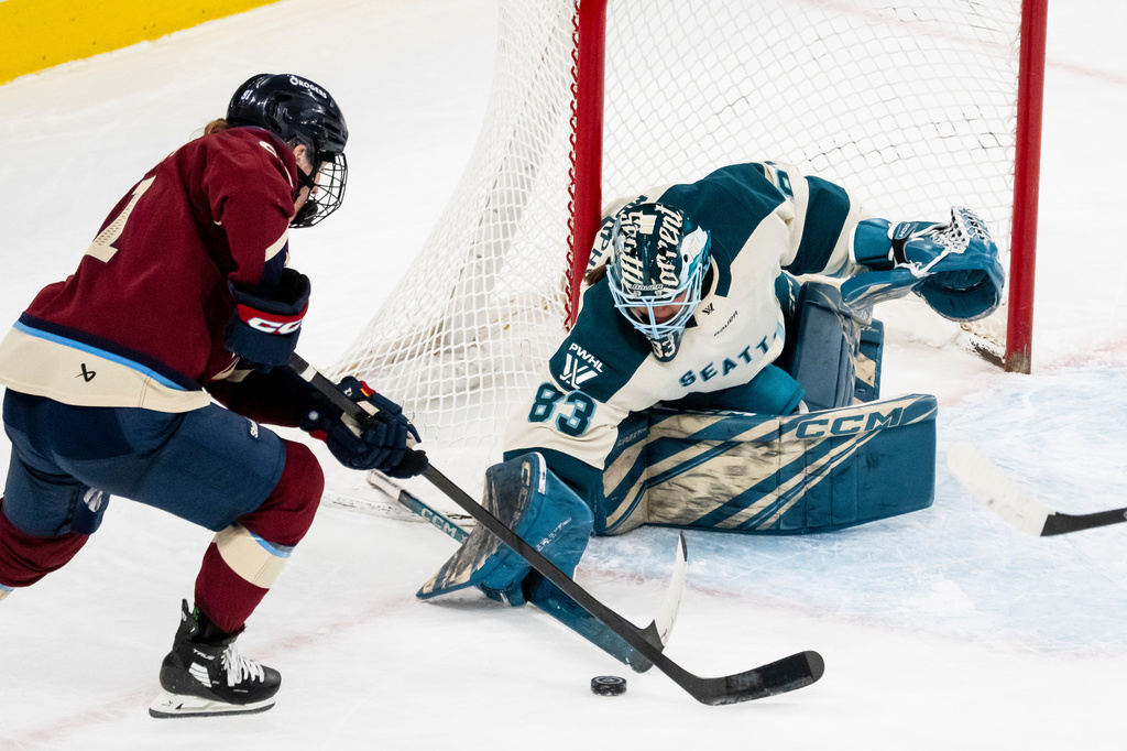 Seattle Torrent goaltender Hannah Murphy (83) makes a save on Montreal Victoire's Maggie Flaherty (91) during third period PWHL hockey action in Laval, Que., on Tuesday, April 7, 2026. (Christopher Katsarov/The Canadian Press via AP)