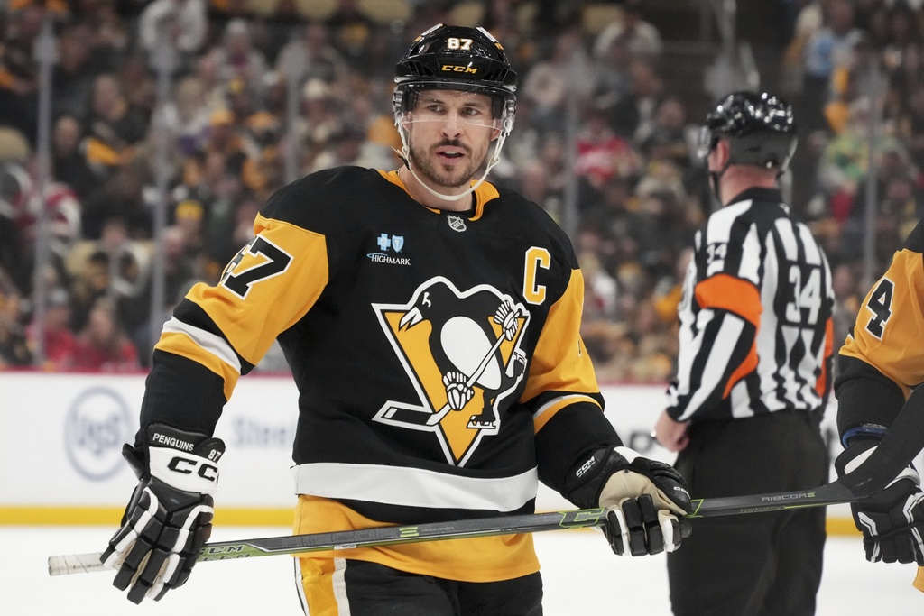 FILE - Pittsburgh Penguins' Sidney Crosby prepares to take a face-off during the second period of an NHL hockey game against the Washington Capitals in Pittsburgh, April 17, 2025. (AP Photo/Gene J. Puskar, file)