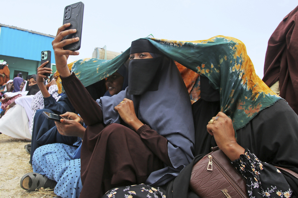 Women take selfie photos during the celebration of Mawlid al-Nabi, the birthday of Prophet Muhammad, in Mogadishu, Somalia, Thursday, Sept. 4, 2025. (AP Photo/Farah Abdi Warsameh)