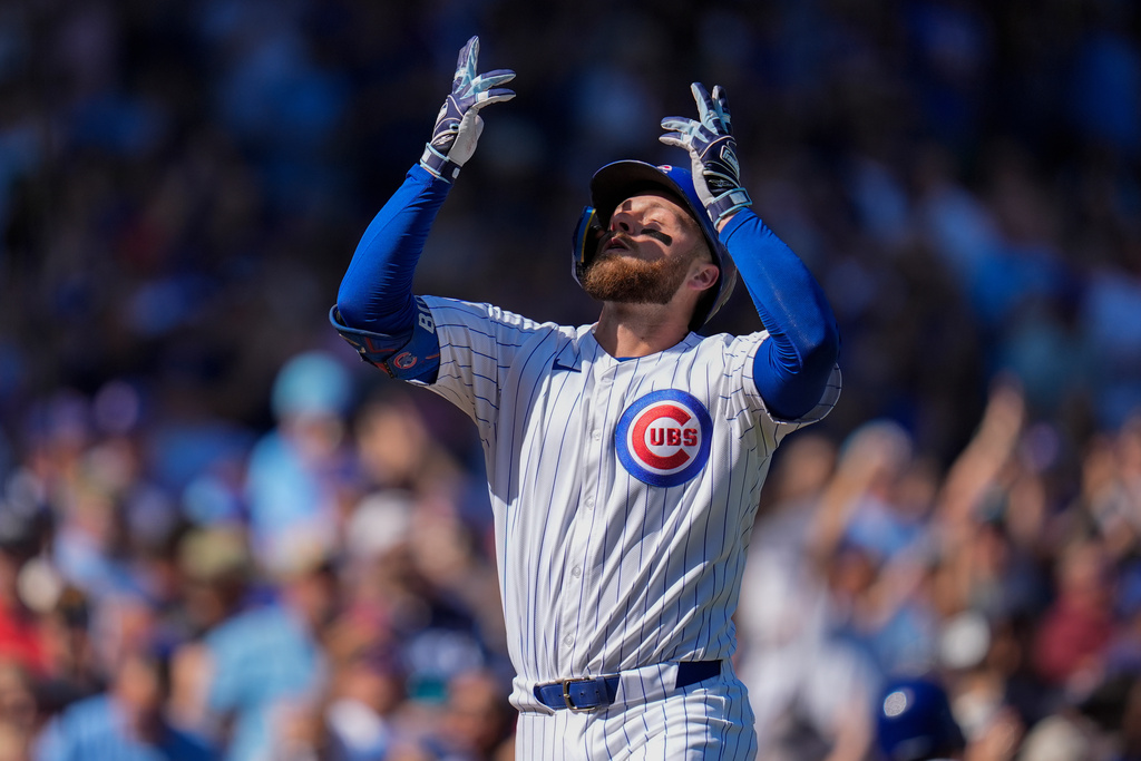 Chicago Cubs' Michael Busch (29) gestures skyward as he crosses home plate after hitting a home run during the first inning of a baseball game against the St. Louis Cardinals, Saturday, Sept. 27, 2025, in Chicago. (AP Photo/Erin Hooley)