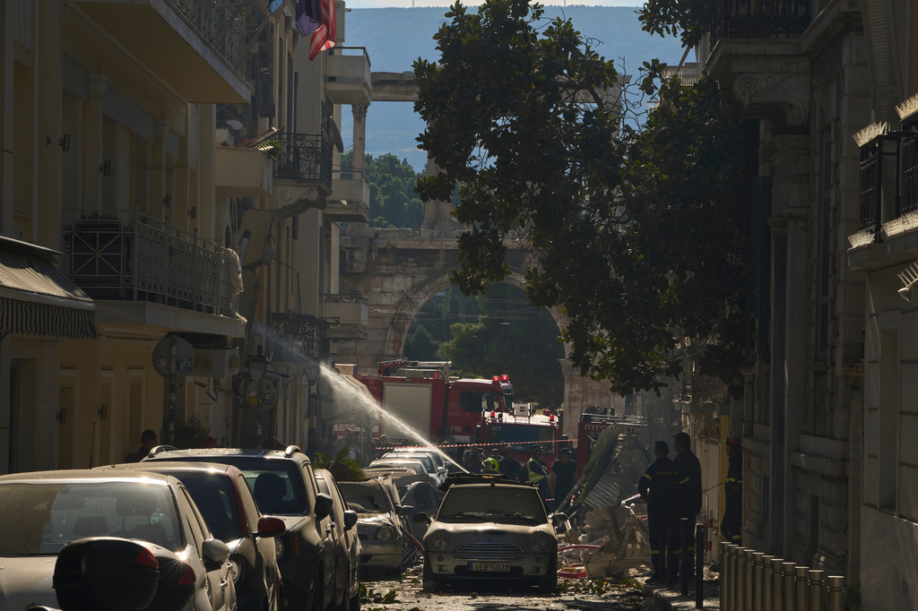 Firefighters work at the scene following a powerful blast that caused a building to collapse and injured at least two people in Athens' Plaka district, with the ancient Hadrian's Arch in the background, Friday, Sept. 25, 2026. (AP Photo/Petros Giannakouris)