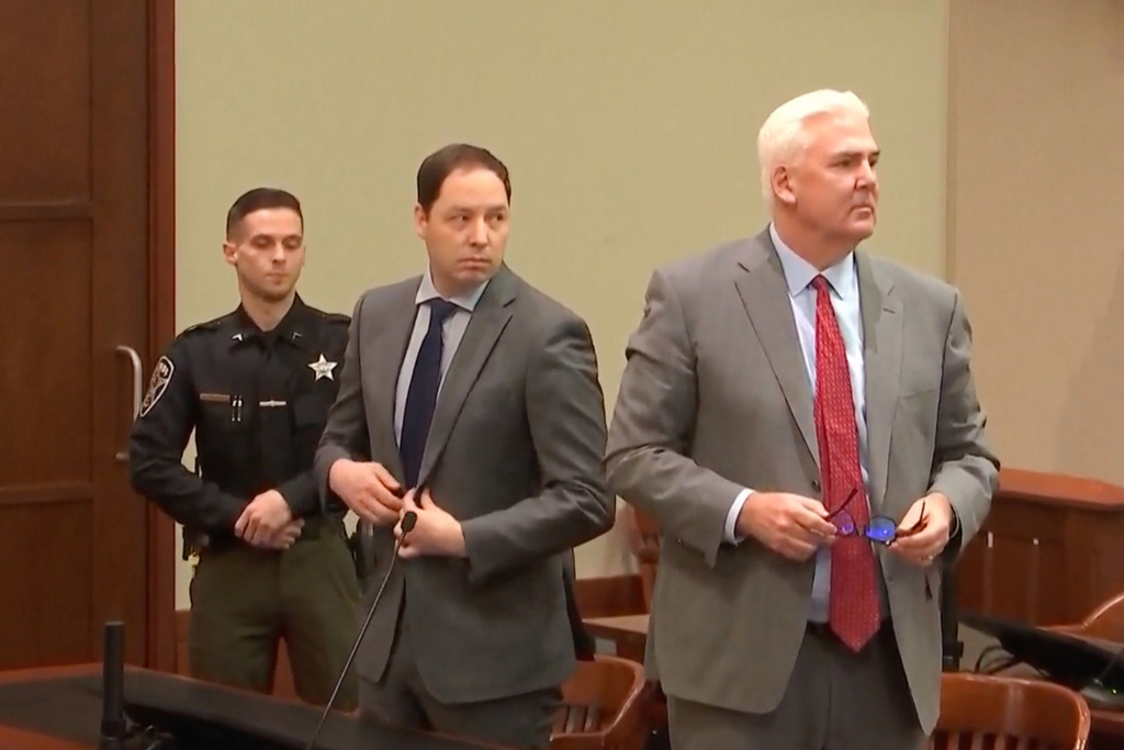 This image taken from Court TV video shows Brendan Banfield, center and defense attorney John Carroll, right, rising to hear the verdict, Monday, Feb. 2, 2026, in Fairfax, Va. (Court TV via AP, Pool)
