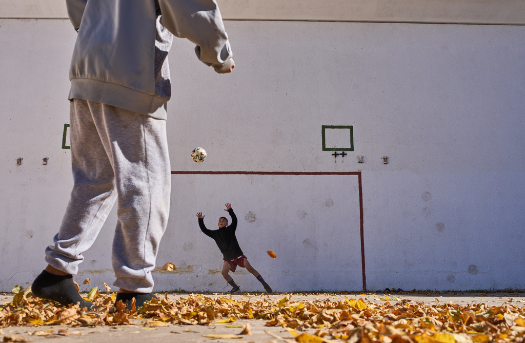 Children of the LT3 soccer club warm up before playing a match against the Grandoli club, where world soccer star Lionel Messi played as a child in Rosario, Argentina, Saturday, May 2, 2026. (AP Photo/Rodrigo Abd)