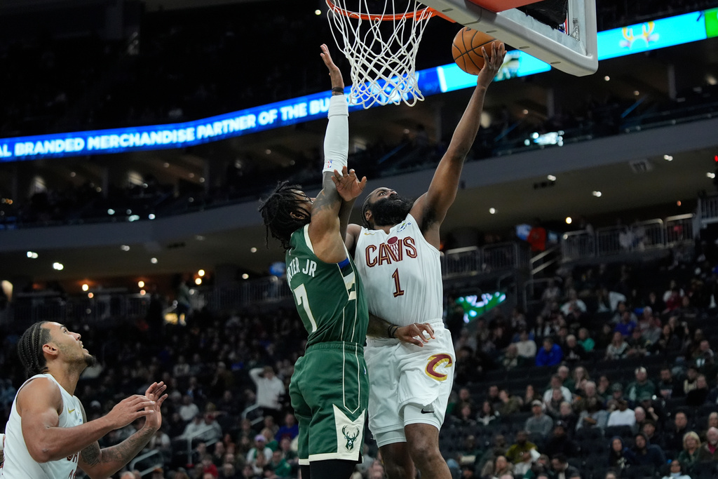 Cleveland Cavaliers' James Harden (1) shoots against Milwaukee Bucks' Kevin Porter Jr. during the first half of an NBA basketball game, Tuesday, March 17, 2026, in Milwaukee. (AP Photo/Aaron Gash)