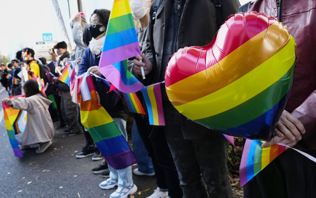 People gather outside a high court before its ruling on same-sex marriage in Tokyo, Friday, Nov. 28, 2025. (Miki Matsuzaki/Kyodo News via AP)