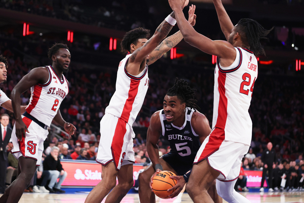 Butler forward Michael Ajayi (5) is surrounded by St. John's defenders during the first half of an NCAA college basketball game, Wednesday, Jan. 28, 2026, in New York. (AP Photo/Heather Khalifa)