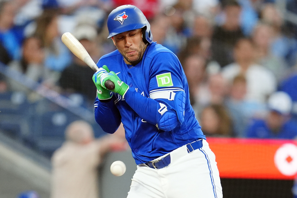 Toronto Blue Jays' designated hitter George Springer (4) is hit by a pitch against the Miami Marlins during fifth inning of a baseball game in Toronto on Tuesday May 26, 2026. (Frank Gunn/The Canadian Press via AP)