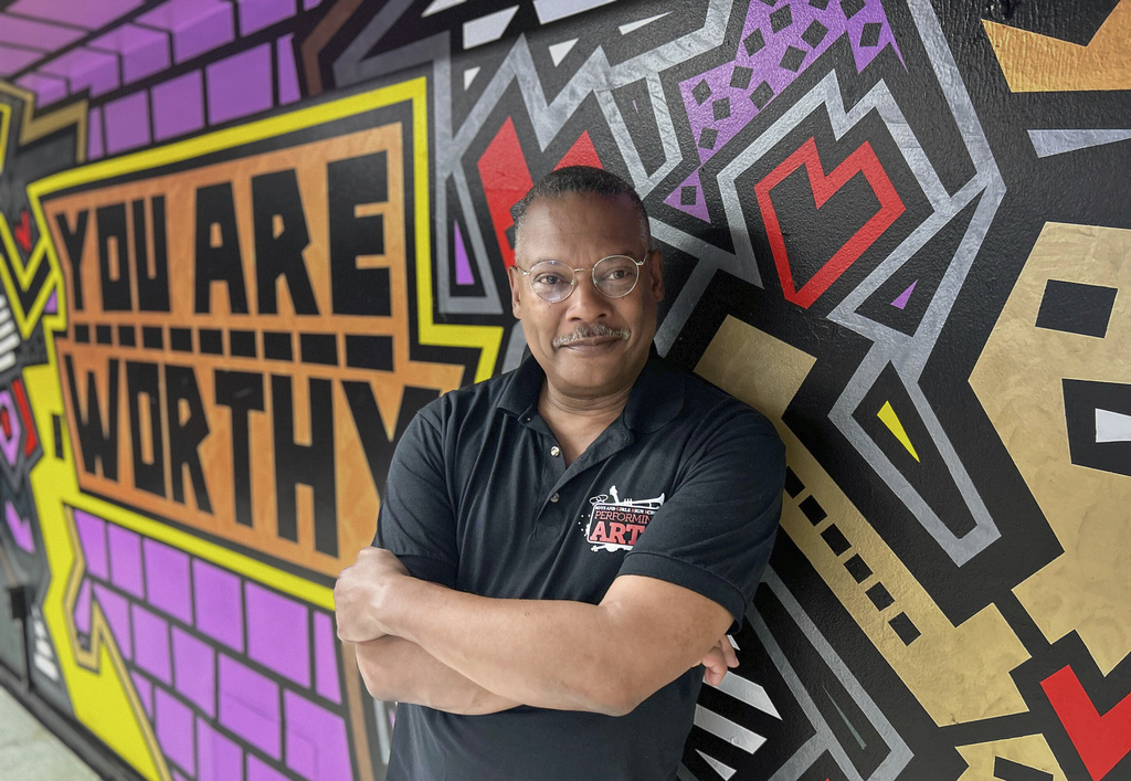 This image released by Carnegie Mellon University shows Gary Edwin Robinson, recipient of the 2025 Excellence in Theatre Education Award, posing in front of a mural at the Boys and Girls High School in the Brooklyn borough of New York on May 7, 2025. (Pam Wigley/Carnegie Mellon University via AP)