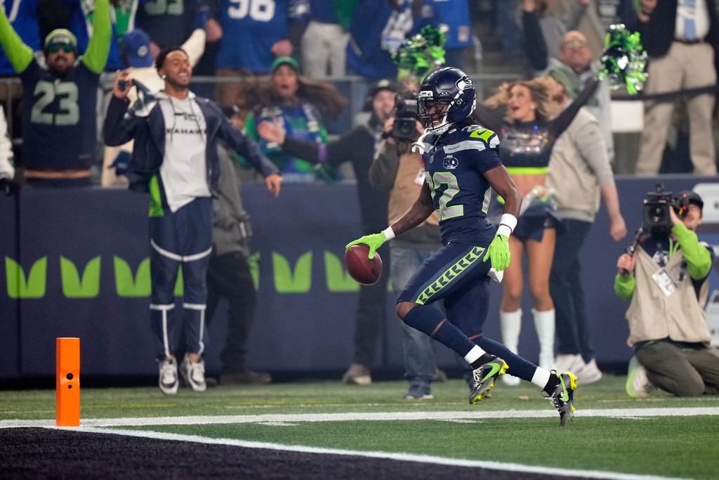 Seattle Seahawks wide receiver Rashid Shaheed (22) runs a kickoff return in for a touchdown during the first half of an NFL football divisional playoff game against the San Francisco 49ers, Saturday, Jan. 17, 2026, in Seattle. (AP Photo/Stephen Brashear)
