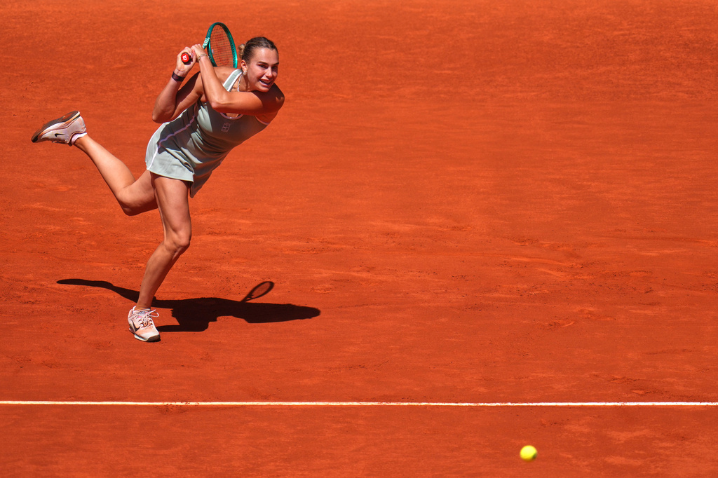 Aryna Sabalenka of Belarus returns the ball to Naomi Osaka of Japan during the Madrid Open tennis tournament in Madrid, Monday, April 27, 2026. (AP Photo/Manu Fernandez)