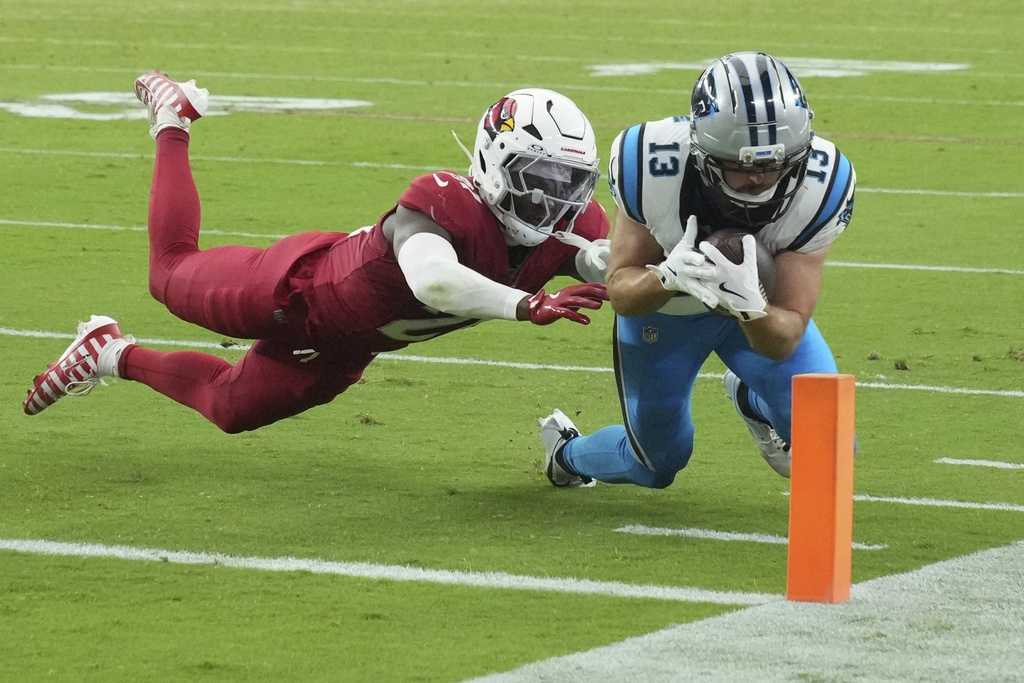 Carolina Panthers wide receiver Hunter Renfrow (13) is stopped short of the goalie by Arizona Cardinals linebacker Mack Wilson Sr. during the second half of an NFL football game, Sunday, Sept. 14, 2025, in Glendale, Ariz. (AP Photo/Rick Scuteri)