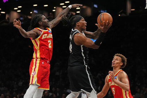 Brooklyn Nets' Terance Mann (14) drives past Atlanta Hawks' Keaton Wallace (2) and Dyson Daniels (5) during the second half of an NBA basketball game Wednesday, Oct. 29, 2025, at Barclays Center in New York. (AP Photo/Frank Franklin II) Brooklyn Nets' Terance Mann (14) drives past Atlanta Hawks' Keaton Wallace (2) and Dyson Daniels (5) during the second half of an NBA basketball game Wednesday, Oct. 29, 2025, at Barclays Center in New York. (AP Photo/Frank Franklin II)