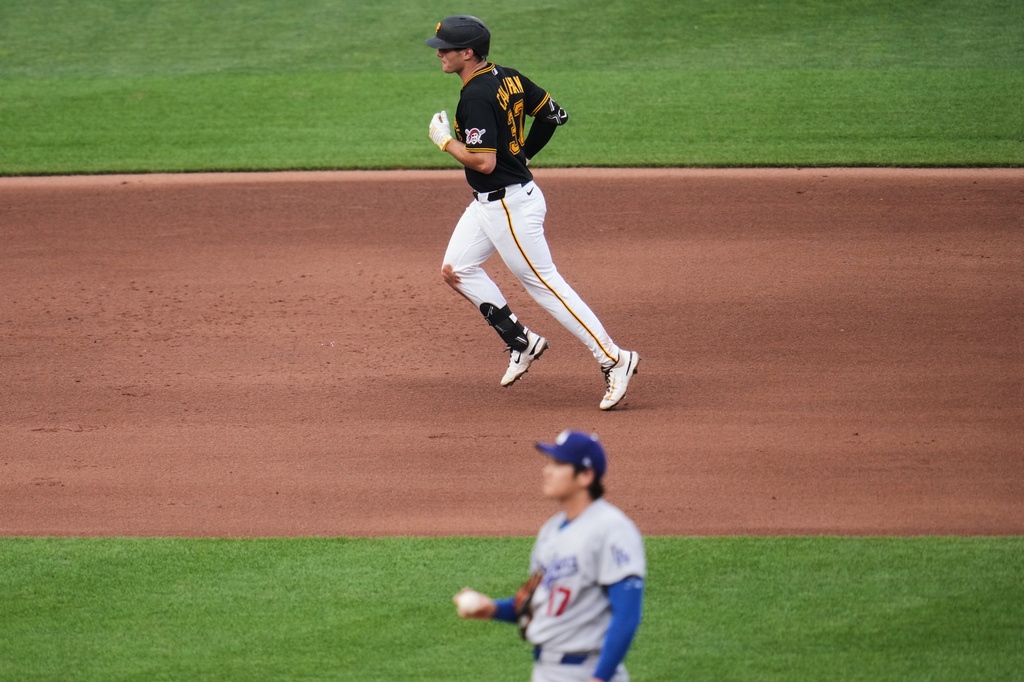 Pittsburgh Pirates' Tyler Callihan, top, rounds the bases after hitting a solo home run off Los Angeles Dodgers two-way player Shohei Ohtani (17) during the fourth inning of a baseball game in Pittsburgh, Wednesday, June 10, 2026. (AP Photo/Gene J. Puskar)
