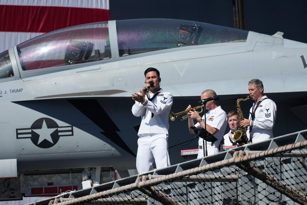 A Navy band performs before President Donald Trump arrives to speak during a celebration for the 250th anniversary of the U.S. Navy aboard the USS Harry S. Truman at Naval Station Norfolk, Sunday Oct. 5, 2025 in Norfolk, Va. (AP Photo/Steve Helber)