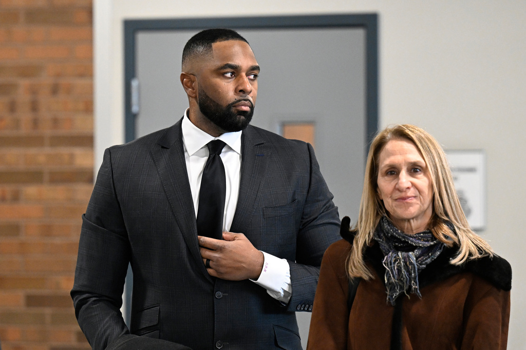 Former Michigan football coach Sherrone Moore, left, stands with his attorney, Ellen K. Michaels, in the lobby of the courthouse, Thursday, Jan. 22, 2026, in Ann Arbor, Mich. (AP Photo/Jose Juarez)