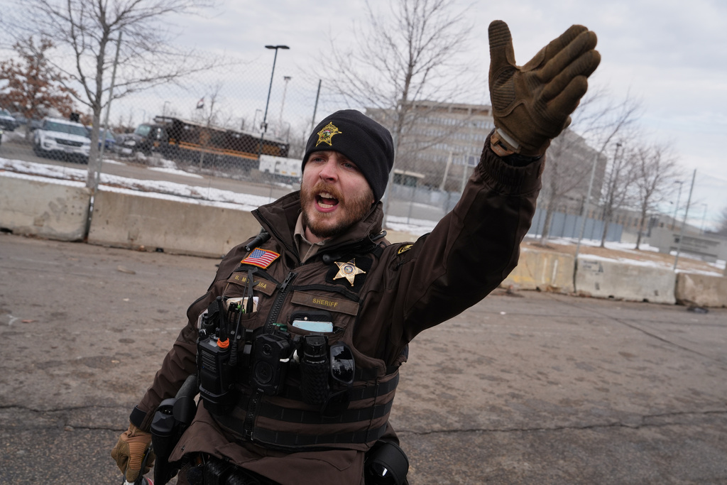 A sheriff's deputy yells at counterprotesters demonstrating against Jake Lang on Saturday, Feb. 7, 2026, in Minneapolis. (AP Photo/Ryan Murphy)