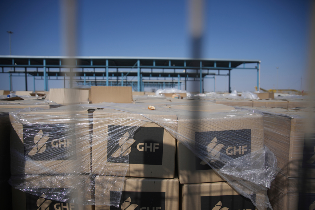 FILE - Piles of humanitarian aid packages from GHFwas, Gaza Humanitarian Foundation, wait to be picked up on the Palestinian side of the Kerem Shalom crossing in the Gaza Strip, Thursday, July 24, 2025. during a media tour organized by the Israeli army. (AP Photo/Ohad Zwigenberg, file)