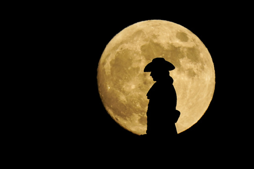 FILE - A strawberry full moon rises behind a statue of William Penn atop City Hall in Philadelphia, Thursday, June 24, 2021. (AP Photo/Matt Rourke, File) FILE - A strawberry full moon rises behind a statue of William Penn atop City Hall in Philadelphia, Thursday, June 24, 2021. (AP Photo/Matt Rourke, File)