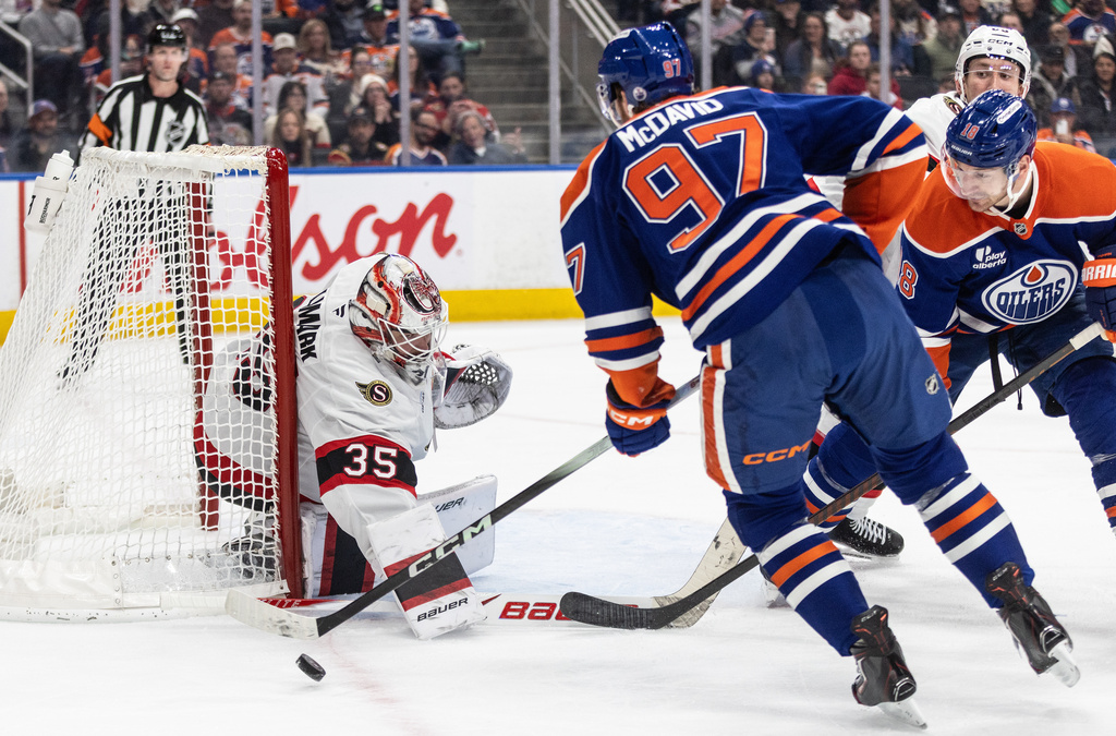 Ottawa Senators goaltender Linus Ullmark (35) makes the save on Edmonton Oilers' Connor McDavid (97) during second period NHL action, in Edmonton on Tuesday, March 3, 2026. (Jason Franson/The Canadian Press via AP)