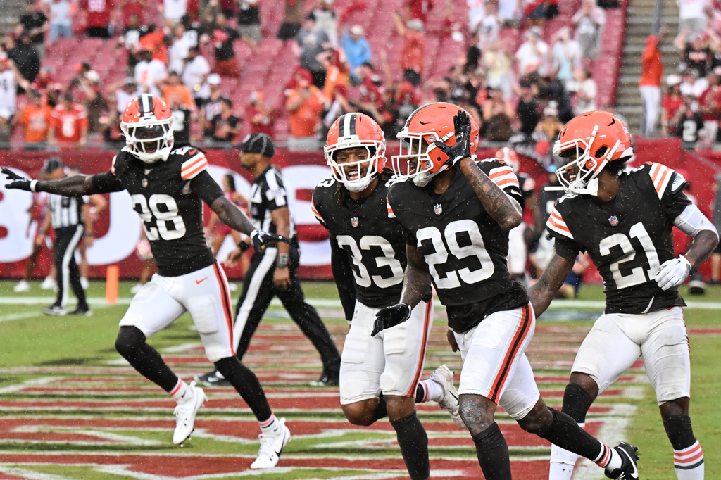 Cleveland Browns safety Emmanuel McNeil-Warren (28), safety Ronnie Hickman (33), cornerback Mekhi Blackmon (29) and cornerback Denzel Ward (21) celebrate after the Tampa Bay Buccaneers were not able to complete a fourth down pass during the second half of an NFL football game in Tampa, Fla., Sunday, Sept. 20, 2026. (AP Photo/Jason Behnken)