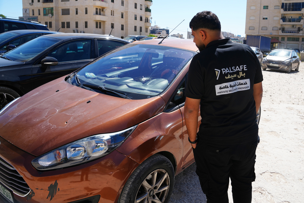 A man inspects the shattered family vehicle of seven month old Palestinian baby boy Sam Fahd Abu Haikal, who was killed on Friday when Israeli soldiers fired at the vehicle carrying him and his parents, in Tel Rumeida, in the West Bank city of Hebron Saturday, June 6, 2026. (AP Photo/Mahmoud Illean)
