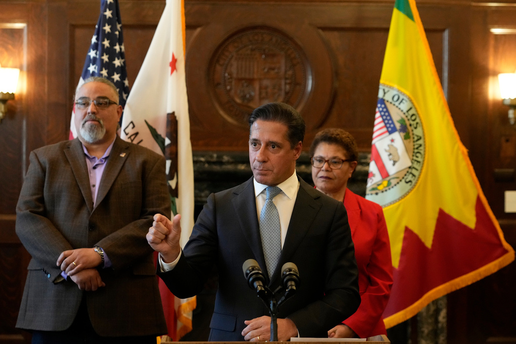 FILE - Los Angeles District Superintendent Alberto Carvalho, at podium, holds a news conference as SEIU Local 99 Executive Director Max Arias, left, and Los Angeles Mayor Karen Bass, right, listen, in Los Angeles City Hall, Friday, March 24, 2023. (AP Photo/Damian Dovarganes, File)