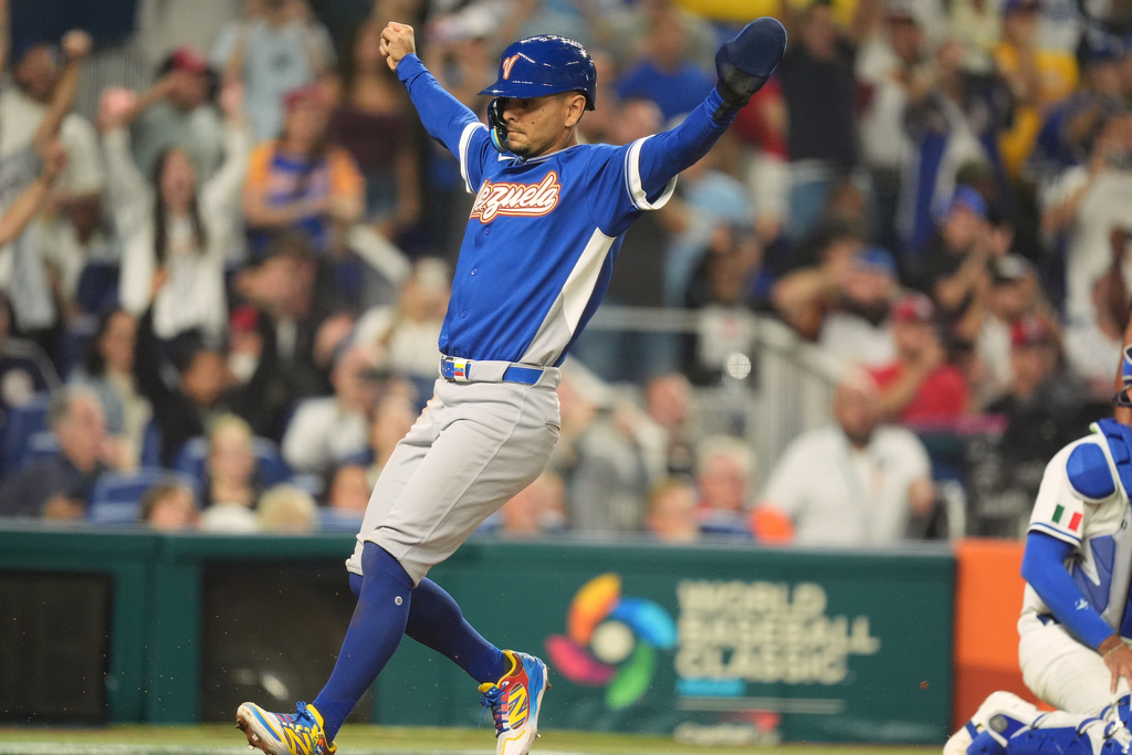 Venezuela Andres Gimenez scores on a single by Ronald Acuña Jr., during the seventh inning of a World Baseball Classic semifinal game against Italy, Monday, March 16, 2026, in Miami. (AP Photo/Rebecca Blackwell)