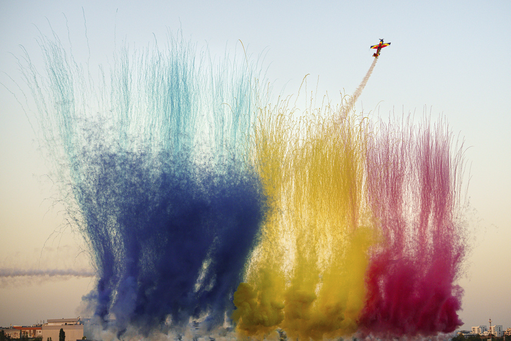 Pilots of the Hawks of Romania aerobatic team perform above the runway of the Aurel Vlaicu airport, as pyrotechnics go off on the first day of the Bucharest International Air Show, BIAS 2025 in Bucharest, Romania, Saturday, Aug. 30, 2025. (AP Photo/Andreea Alexandru)