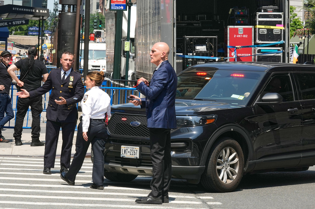 Security personnel meet outside New York's Madison Square Garden, Wednesday, July 1, 2026. (AP Photo/Richard Drew)