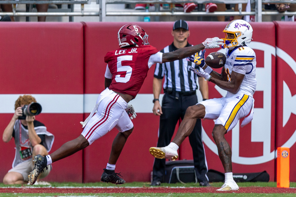 East Carolina quarterback Daulton Phalines (11) grabs a touchdown pass with Alabama linebacker Duke Johnson II (15) defending during the first half of an NCAA college football game Saturday, Sept. 5, 2026, in Tuscaloosa, Ala. (AP Photo/Vasha Hunt)