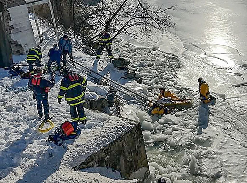 Firefighters with the Norwalk Fire department pull a swan from the Norwalk River after freeing it from the ice, Tuesday, Feb. 3, 2026 in Norwalk, Conn. (Norwalk Fire Department via AP)