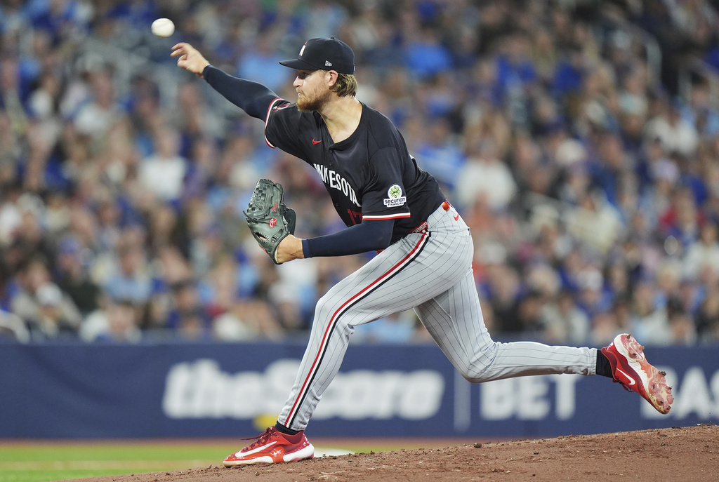 Minnesota Twins pitcher Bailey Ober works against the Toronto Blue Jays during the first inning of a baseball game in Toronto on Tuesday, Aug. 26, 2025. (Frank Gunn/The Canadian Press via AP)