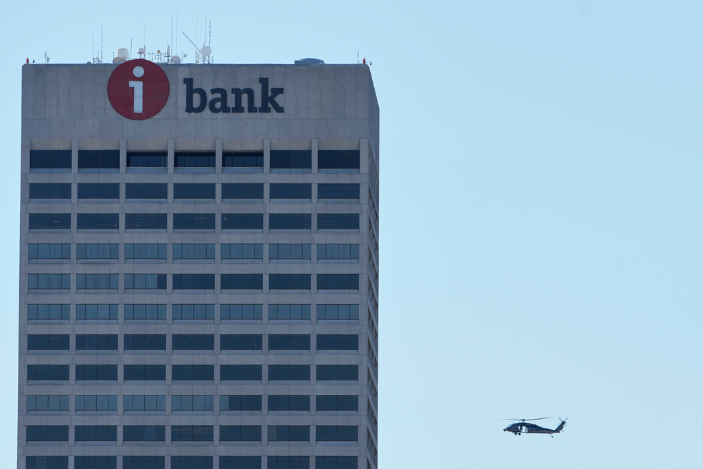 A Blackhawk helicopter flies over the skyline in Memphis, Tenn., Wednesday, Oct. 8, 2025. (AP Photo/George Walker IV)