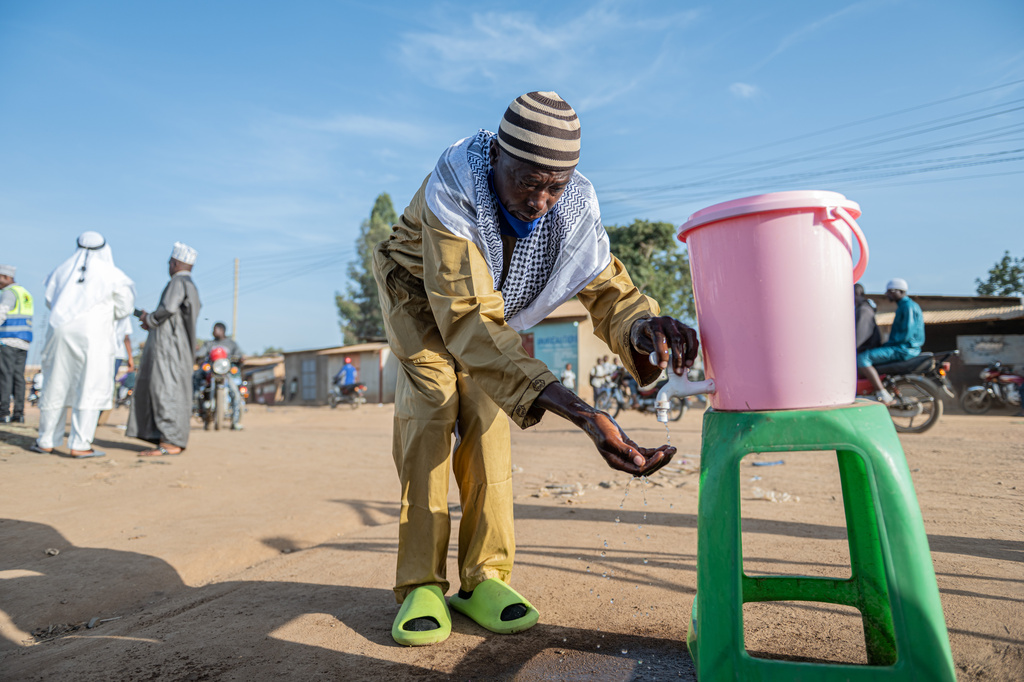 A Muslim washes his hands as a precaution against Ebola before attending the Eid al-Adha prayers at Sayo Muhamed School in Bunia, Congo, Wednesday, May 27, 2026. (AP Photo/Moses Sawasawa)
