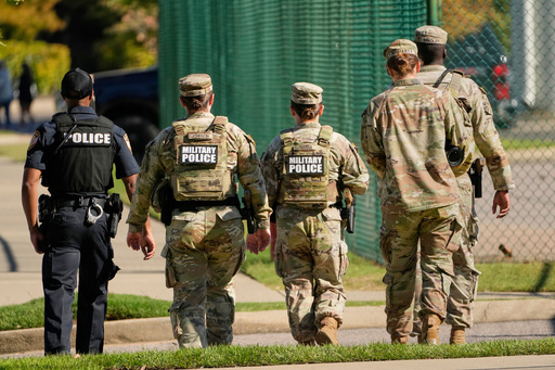 A Memphis Police Department officer, left, patrols with members of the National Guard, Friday, Oct. 10, 2025, in Memphis, Tenn. (AP Photo/George Walker IV) A Memphis Police Department officer, left, patrols with members of the National Guard, Friday, Oct. 10, 2025, in Memphis, Tenn. (AP Photo/George Walker IV)