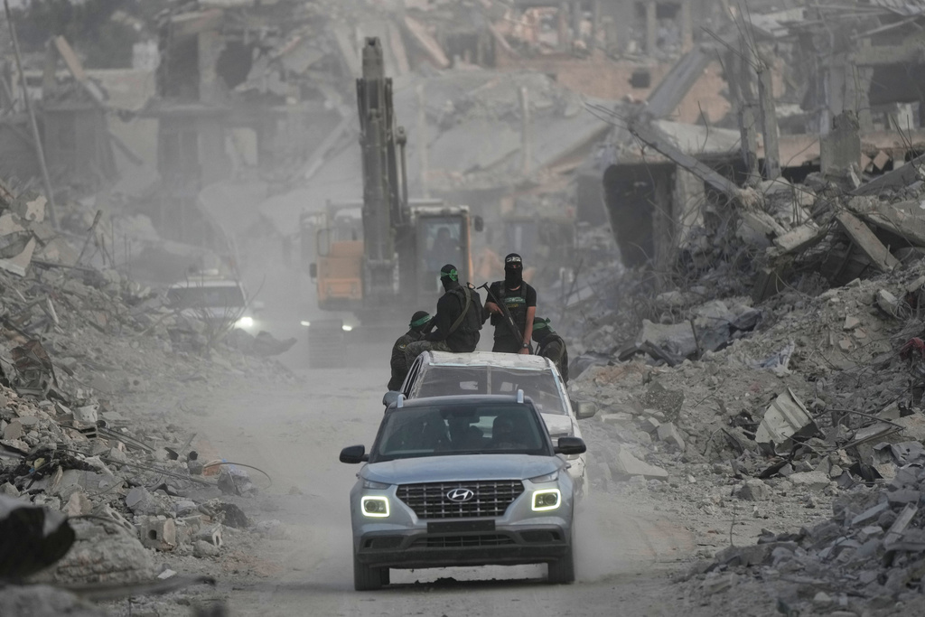 Hamas militants and Egyptian workers search for the bodies of Israeli hostages in the Shijaiyah neighborhood of Gaza City Wednesday, Nov. 5, 2025. (AP Photo/Jehad Alshrafi)