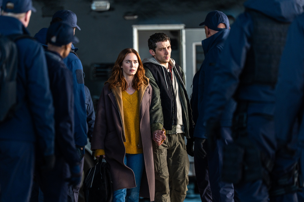 This image released by Universal Pictures shows Emily Blunt, left, and Josh O'Connor in a scene from "Disclosure Day." (Niko Tavernise/Universal Pictures and Amblin Entertainment via AP)