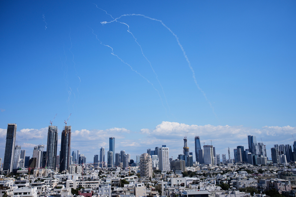 Israeli air defense system fires to intercept missiles during an Iranian attack over central Israel, Sunday, March 1, 2026. (AP Photo/Ohad Zwigenberg)