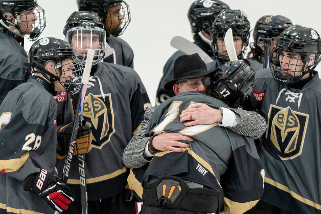 Blackstone Valley Schools head coach Chris Librizzi embraces Colin Dorgan after Dorgan scored the double-overtime game-winning goal against Portsmouth High School in the Rhode Island high school hockey state semifinal, Wednesday, March 11, 2026, at Schneider Arena on the campus of Providence College in Providence, R.I. (Courtesy of T.J. Auclair & Kyle Auclair/Little Big Leaguers Photography via AP)