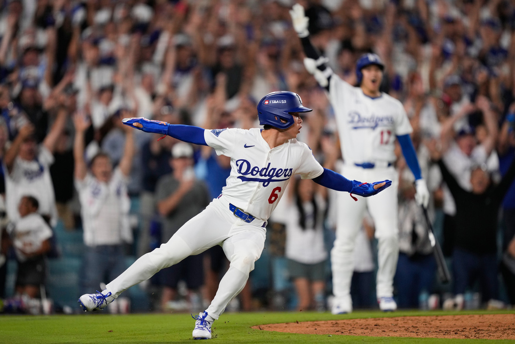 Los Angeles Dodgers' Hyeseong Kim reacts after scoring the game-winning run on a ground ball by Andy Pages and a throwing error by Phillies pitcher Orion Kerkering during the eleventh inning in Game 4 of baseball's National League Division Series Thursday, Oct. 9, 2025, in Los Angeles. (AP Photo/Mark J. Terrill)