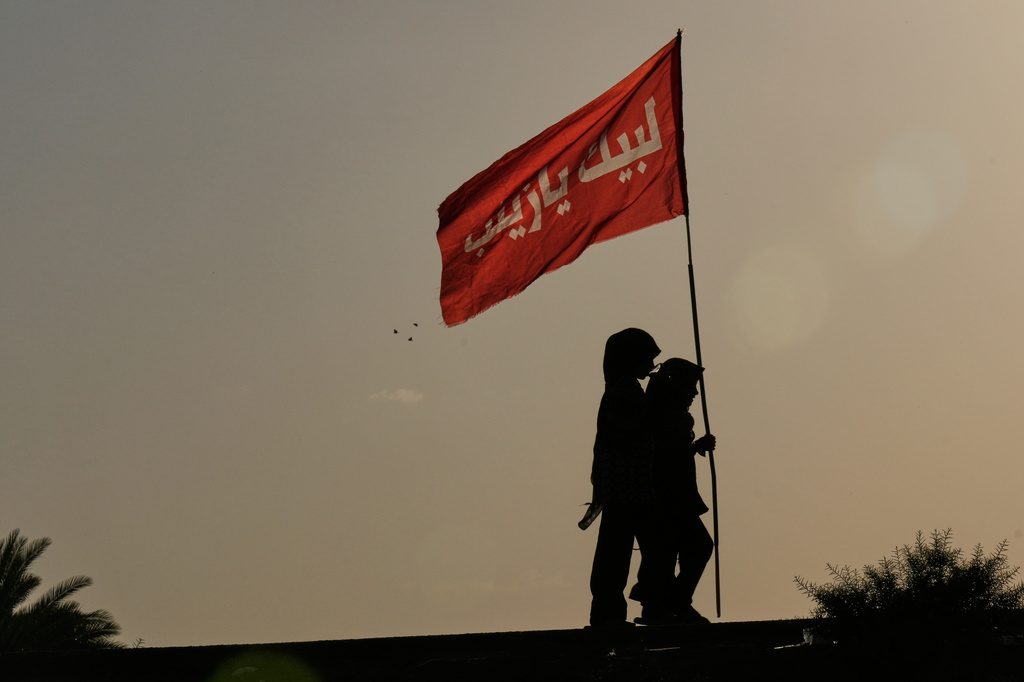 Shiite pilgrims march to Karbala for Arbaeen, the annual Shiite commemoration marking 40 days after Ashura, in Babil, Iraq, Saturday, Aug. 1, 2026. (AP Photo/Hadi Mizban)