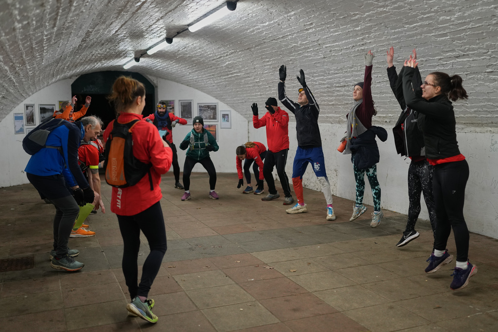 Participants in the Goodgym group exercise after collecting litter to keep the River Thames free of plastic and other waste in London, Wednesday, Jan. 14, 2026. (AP Photo/Kirsty Wigglesworth)