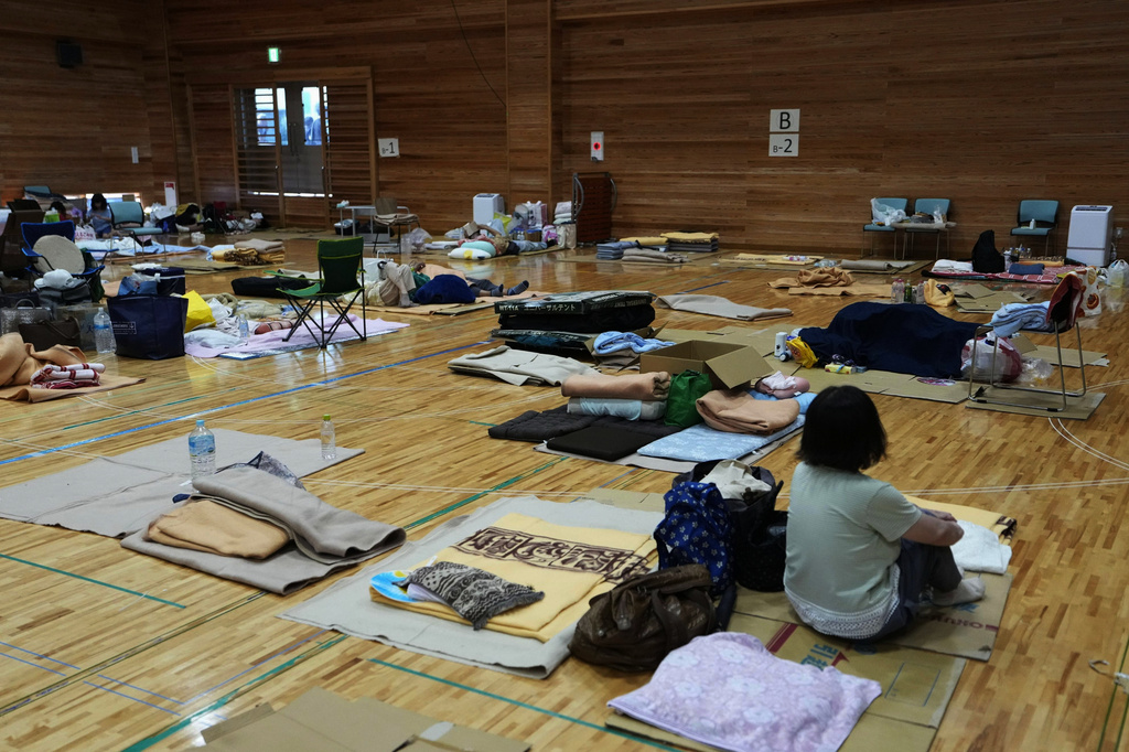 People rest at an evacuation center in Uki, southern Japan, Sunday, Aug. 2, 2026, after recent earthquakes. (Yuta Omori/Kyodo News via AP)